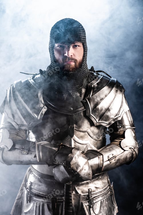 Preview: handsome knight in armor looking at camera on black background