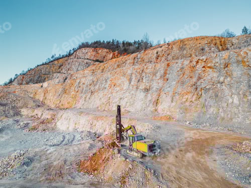 Preview: Yellow excavator digging rocks at the quarry, doing all the hard work