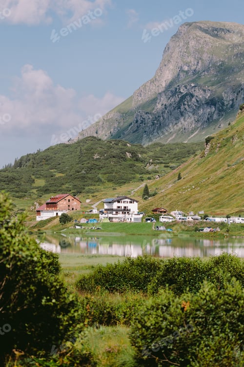 Preview: beautiful mountain village with lake and green hills