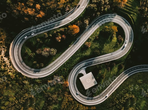 Preview: Aerial view of winding curved road with helipad and colourful autumn foliage in Italy