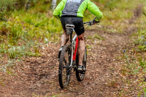 Preview: dirty man cyclist riding mountain bike