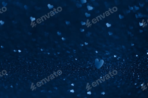 Preview: Macro shot of blue heart on a background with hearts bokeh.