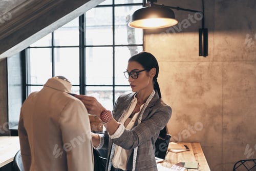Preview: Woman Fitting Clothes on Mannequin in Fashion Studio
