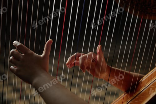 Preview: Hands of Woman Playing Harp Plucking Strings during Classical Music Performance Indoors