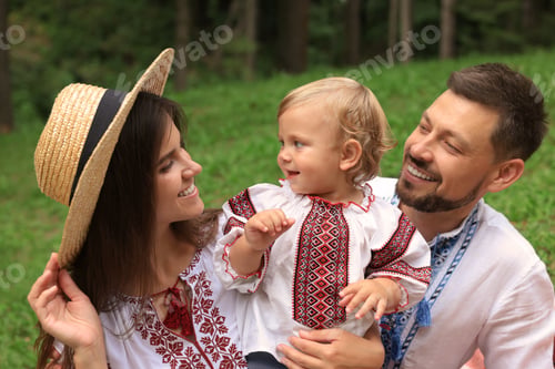 Preview: Happy family in Ukrainian national clothes outdoors