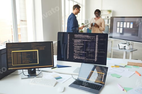 Preview: Computers with Code on Screen in IT Office
