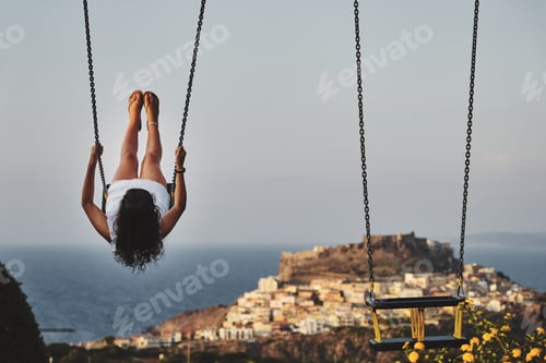 Preview: Beautiful shot of a female swinging with a blurred background. great for articles