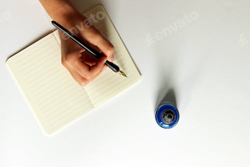 Preview: Female hand writing with ink bottle