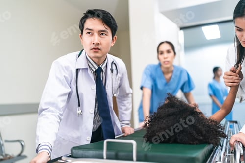 Preview: young handsome Asian male doctor rushing in hospital during emergency with patient