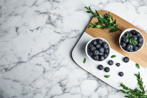 Preview: Composition with blueberries and space for text on marble table, flat lay