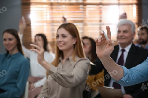 Preview: People raising hands to ask questions at seminar in office, closeup
