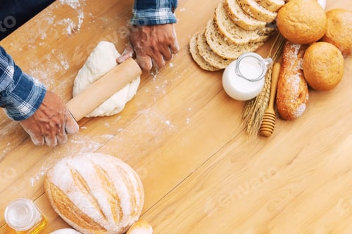 Preview: Man baking fresh bread on tray in garden with nature background.