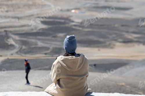 Preview: Female relaxing atop a rugged mountain peak, the Cold Desert Spiti Valley