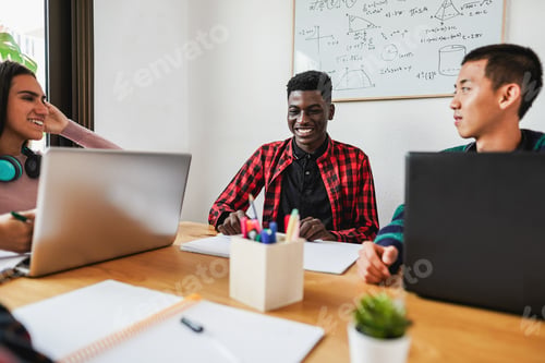 Preview: Multiracial students reading books and using laptop while studying together - Back to school concept