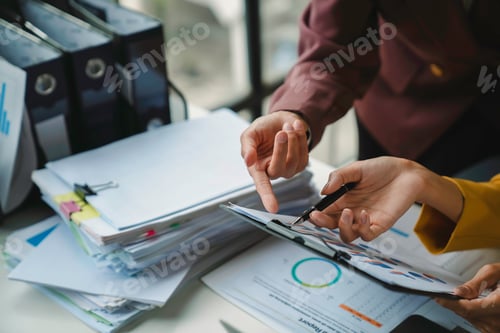 Preview: Business people analyzing financial charts and graphs showing company results