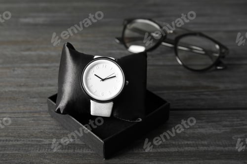 Preview: Composition with stylish wrist watch on wooden background. Fashion accessory