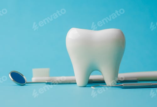 Preview: Large white tooth model with dental mirror and tools on blue background for dental care