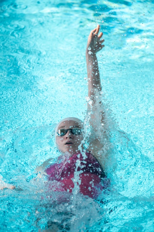 Preview: Swimmer girl swims backstroke swimming style in the pool
