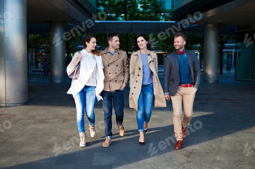 Preview: Four mid adult friends walking together