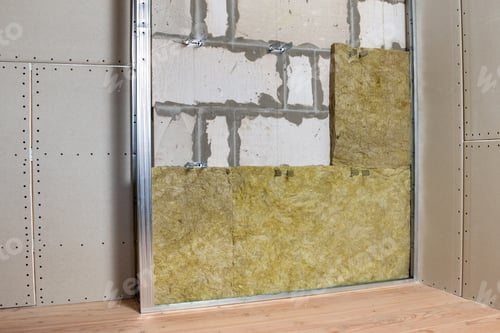 Preview: Wall of a room under renovation with mineral rock wool insulation and metal frame prepared for