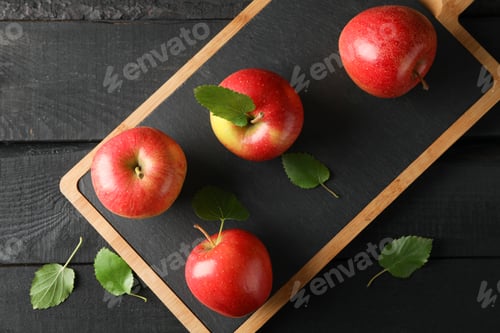 Preview: Apples and cutting board on wooden background, space for text