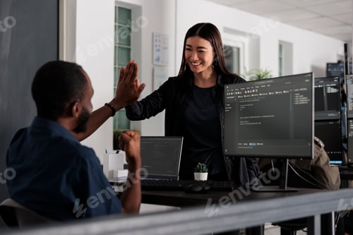 Preview: Happy system engineers celebrating successful code script compiling