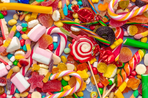 Preview: Colorful candies on table on blue background