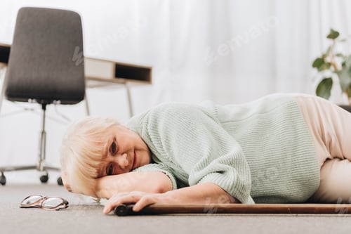 Preview: lonely retired woman lying on floor in living room