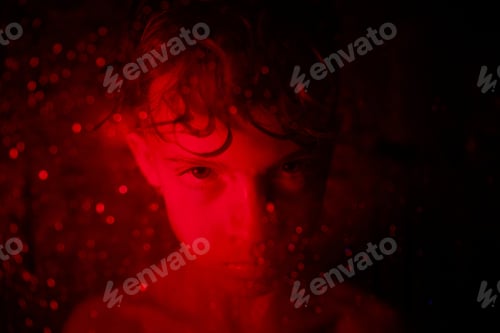 Preview: Offended boy with wet hair in red light