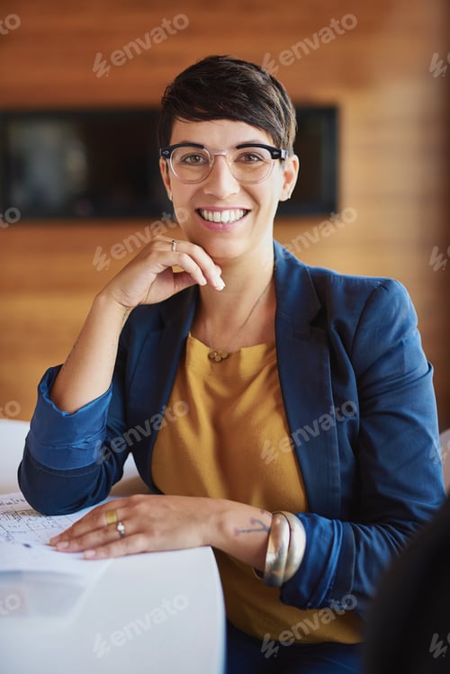 Preview: Smiling Woman at Work Sitting at Table