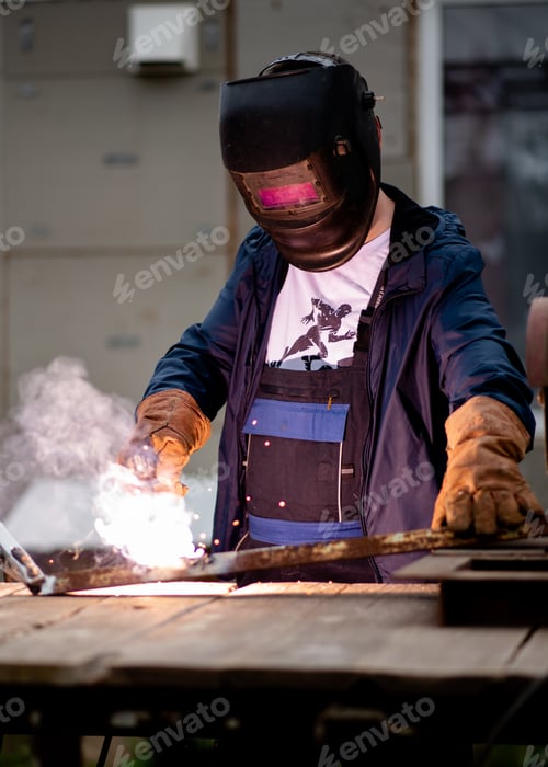 Preview: The man works with a welding machine.