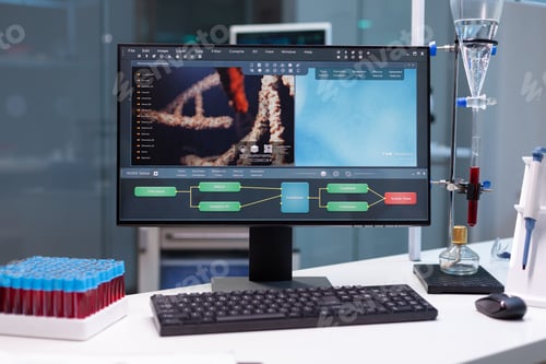Preview: Computer standing on table with microbiology research on display during pharmaceutic biochemical