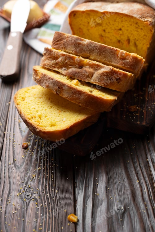 Preview: Homemade cornbread slices and butter on kitchen table