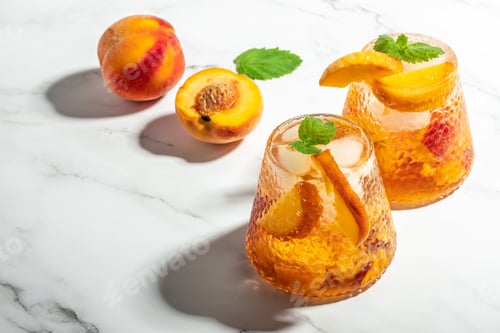 Preview: Refreshing Peach Bourbon Smash Cocktail with ice cubes, and mint in glass. Long banner format