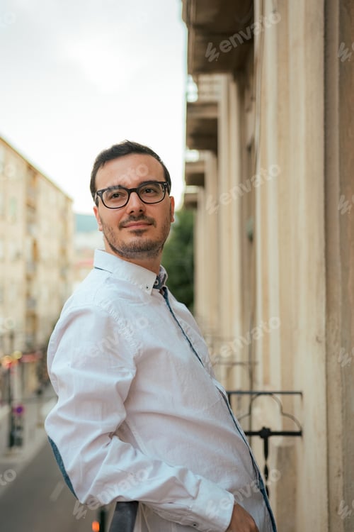 Preview: Happiness man smiles and poses in a balcony