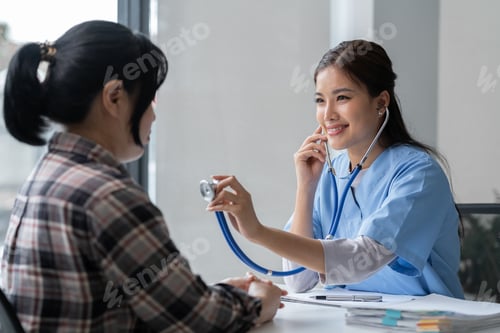 Preview: Asian female doctor using a stethoscope to examine a patient, ask for information, give advice, comf