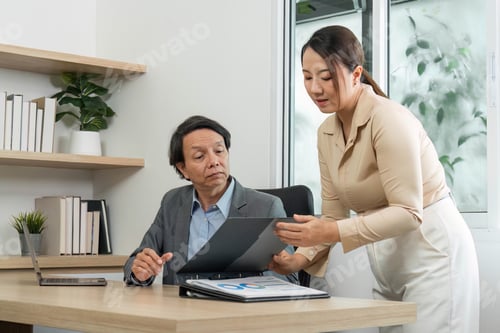 Preview: Financial Presentation and Review. Businesswoman presenting data to a colleague during a meeting.