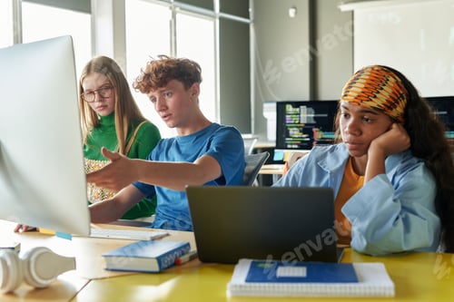Preview: Group of People Sitting at Desk with Computers IT Class in School in Classroom