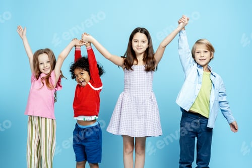 Preview: Diverse children friends holding hands forming a team on a blue background