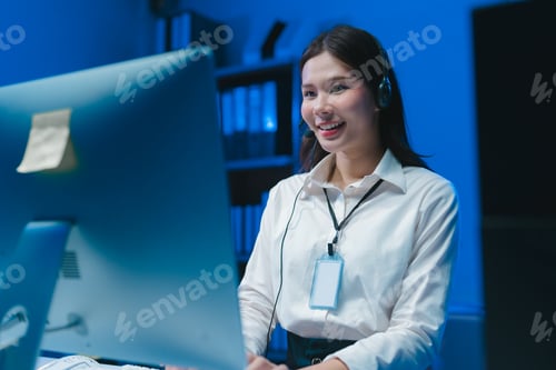 Preview: Asian female telemarketer working late night shift at office answering calls