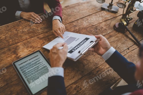 Preview: People signing legal contract agreement at desk