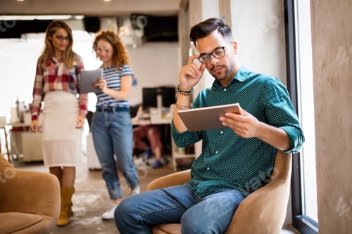 Preview: Young man using technology, digital tablet in corporate business office