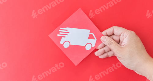 Preview: Female hand holding delivery truck shape symbol on red background