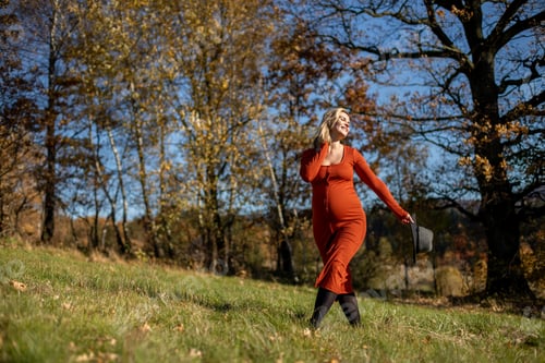 Preview: Happiness concept pregnant woman walking on grass field