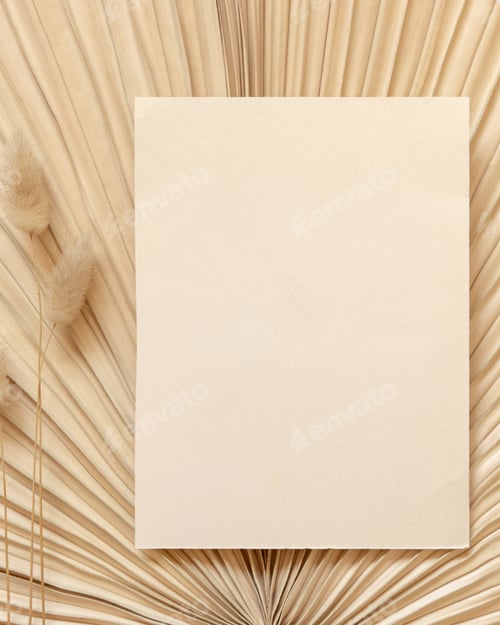 Preview: Blank card on dry beige palm leaf near hare's tail grass top view, boho wedding mockup