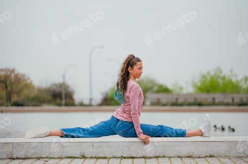 Preview: Portrait of a girl doing rhythmic gymnastics outdoors.