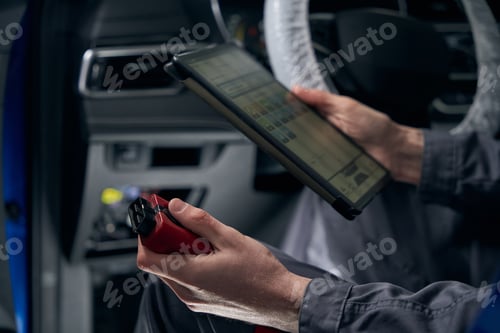 Preview: Male inspecting board computer system in the workshop