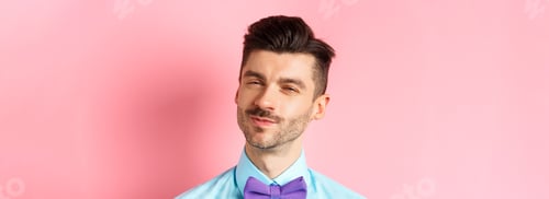 Preview: Close-up of smiling young guy with moustache, squinting intrigued, listening to something