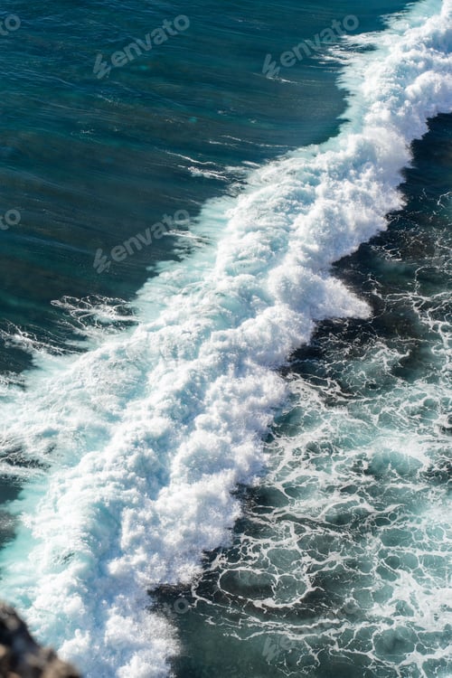 Preview: Top down of waves crashing in ocean near Uluwatu temple in Bali, Indonesia