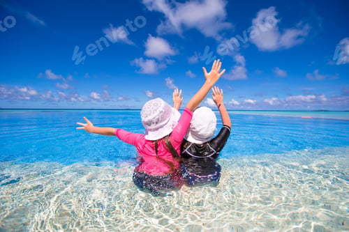 Preview: Adorable little girls playing in outdoor swimming pool